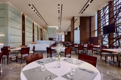 An elegantly modern restaurant offering spacious seating and sweeping views.